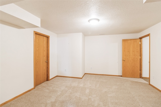 carpeted spare room with a textured ceiling