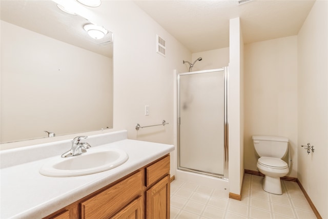 bathroom with vanity, toilet, and an enclosed shower