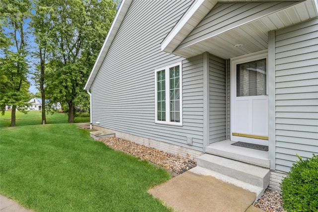 property entrance with a yard