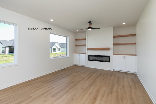 unfurnished living room with ceiling fan and light hardwood / wood-style floors