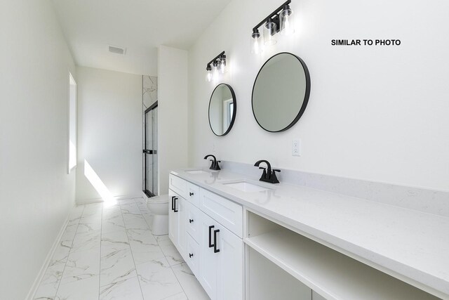 bathroom featuring vanity, toilet, and walk in shower