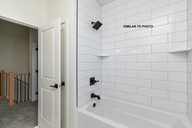 bathroom featuring tiled shower / bath