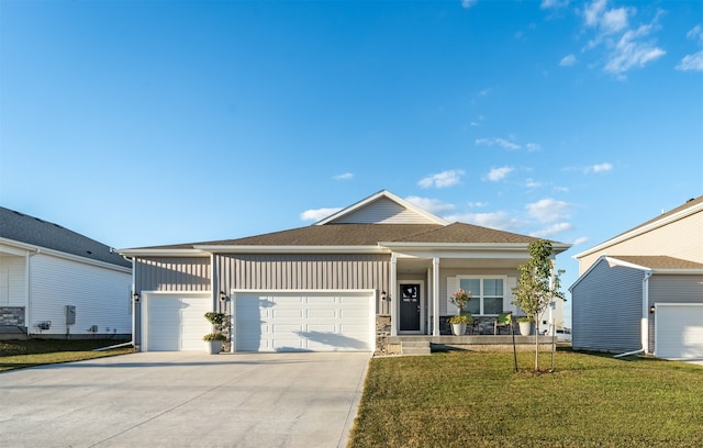 view of front of house with a garage and a front lawn