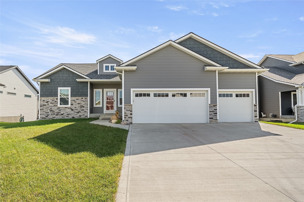 craftsman-style home with a front lawn and a garage