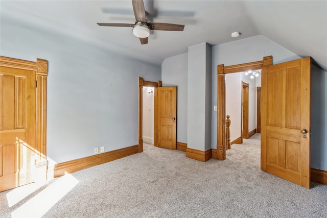 unfurnished bedroom featuring vaulted ceiling, ceiling fan, and light colored carpet