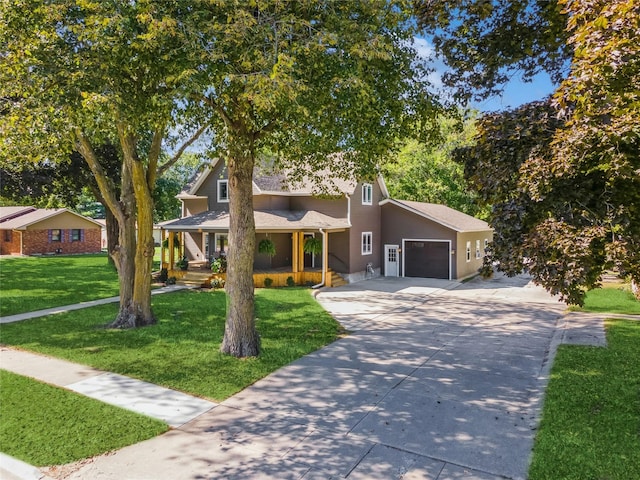 613 N State St, Pleasantville, IA 50225 - view of front of property with a front lawn, covered porch, roof with shingles, concrete driveway, and an attached garage
