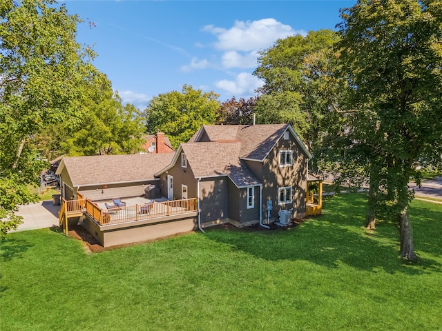 back of property featuring a wooden deck, a yard, and central AC