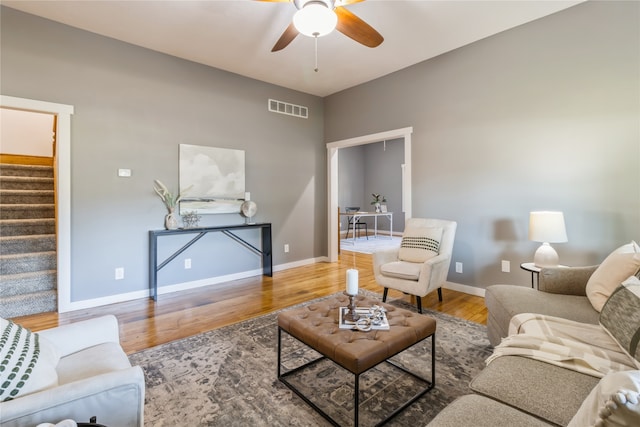 living room featuring ceiling fan and hardwood / wood-style flooring