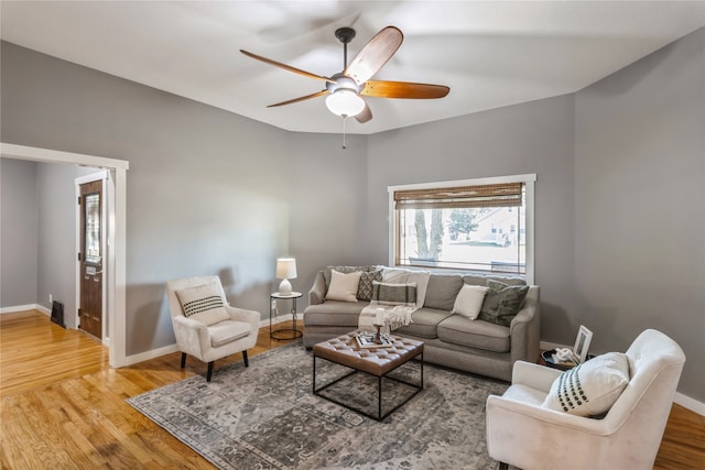 living room featuring ceiling fan and hardwood / wood-style flooring