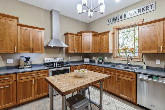 kitchen with pendant lighting, stainless steel appliances, an inviting chandelier, sink, and wall chimney range hood