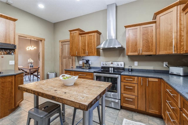 kitchen with wall chimney range hood, light tile patterned flooring, an inviting chandelier, and stainless steel electric range oven