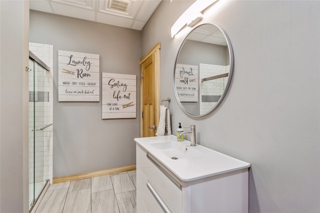 bathroom featuring vanity and a shower with shower door