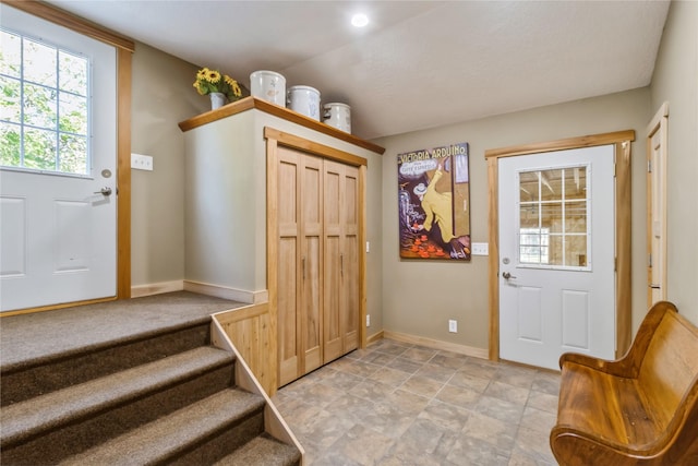 613 N State St, Pleasantville, IA 50225 - entryway featuring baseboards, stone finish flooring, and stairs