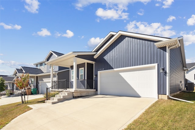 view of front of property with cooling unit, a front lawn, a porch, and a garage