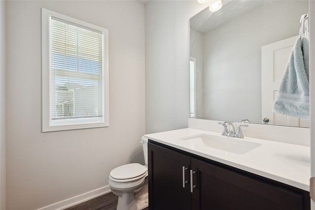 bathroom featuring vanity, hardwood / wood-style floors, and toilet