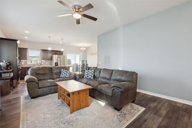 living room with ceiling fan, sink, and dark hardwood / wood-style flooring