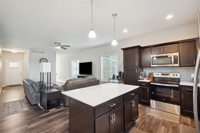 kitchen with dark brown cabinetry, dark hardwood / wood-style flooring, ceiling fan, and stainless steel appliances