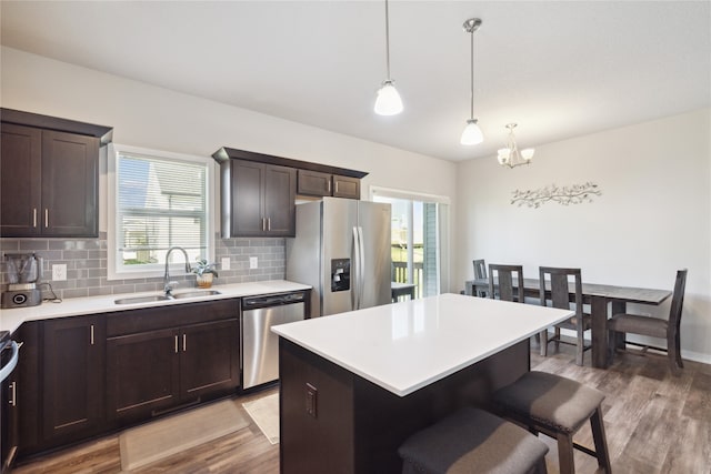 kitchen featuring pendant lighting, a chandelier, appliances with stainless steel finishes, and plenty of natural light