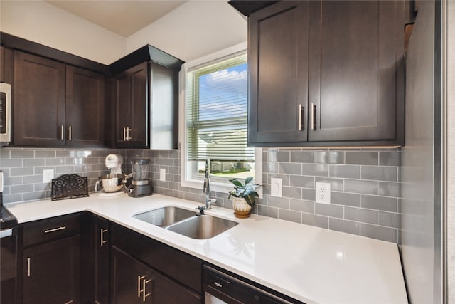 kitchen with backsplash, plenty of natural light, dark brown cabinetry, and sink