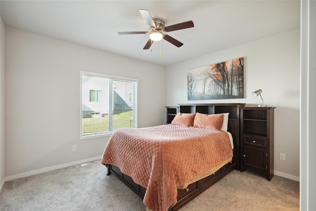 bedroom featuring ceiling fan and light colored carpet