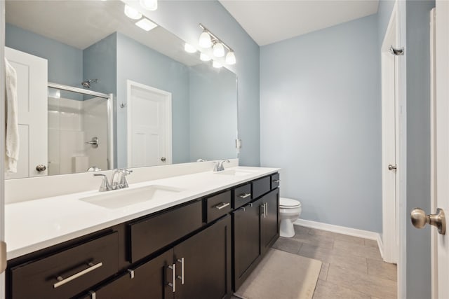 bathroom with tile patterned flooring, a shower with door, toilet, and vanity