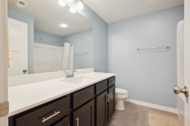 bathroom with tile patterned floors, curtained shower, vanity, and toilet