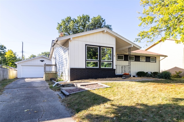 view of front of property with an outbuilding, a front yard, and a garage