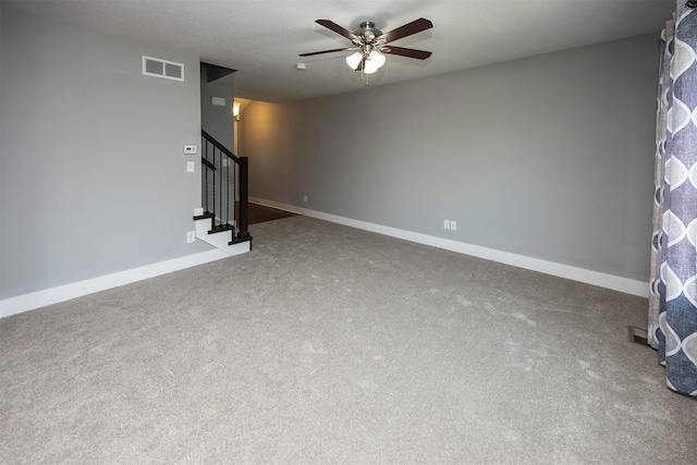 unfurnished living room featuring ceiling fan and carpet floors