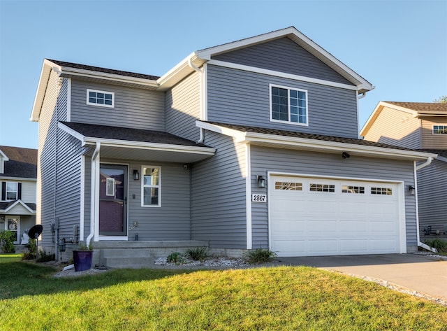 view of front facade with a garage and a front yard