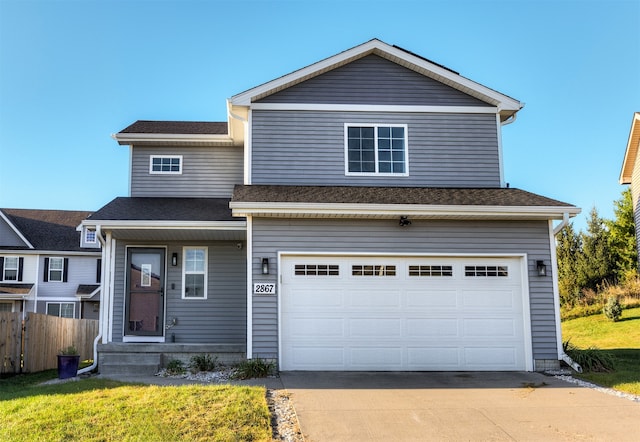 view of front of house featuring a front lawn and a garage