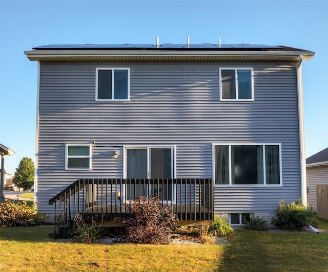 back of house featuring a deck and a yard