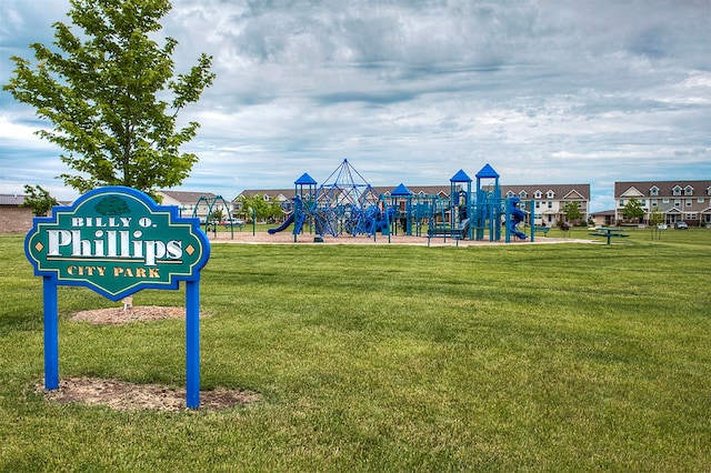 view of home's community with a playground and a lawn