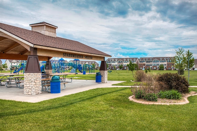 exterior space with a playground, a gazebo, and a yard