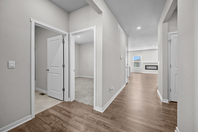 corridor with light hardwood / wood-style floors