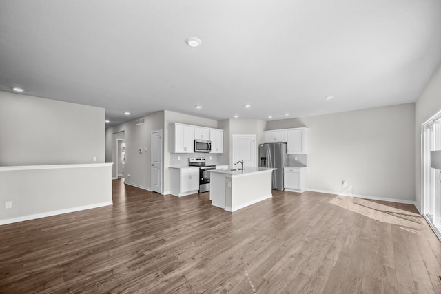 unfurnished living room featuring sink and hardwood / wood-style floors