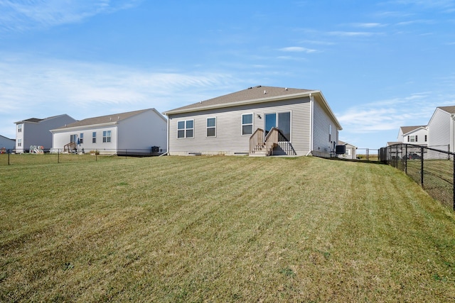 rear view of house with a lawn