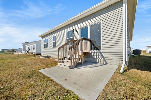 manufactured / mobile home with central AC unit and a front lawn