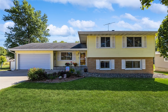 split level home featuring a front yard and a garage