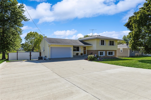 view of front of house with a front yard and a garage