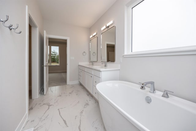 bathroom featuring vanity and a tub to relax in