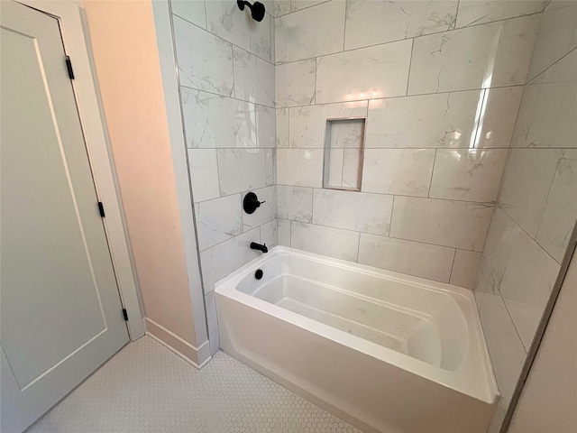 bathroom with tiled shower / bath and tile patterned floors