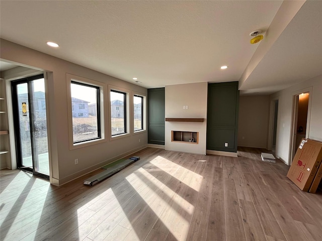 unfurnished living room with light hardwood / wood-style flooring