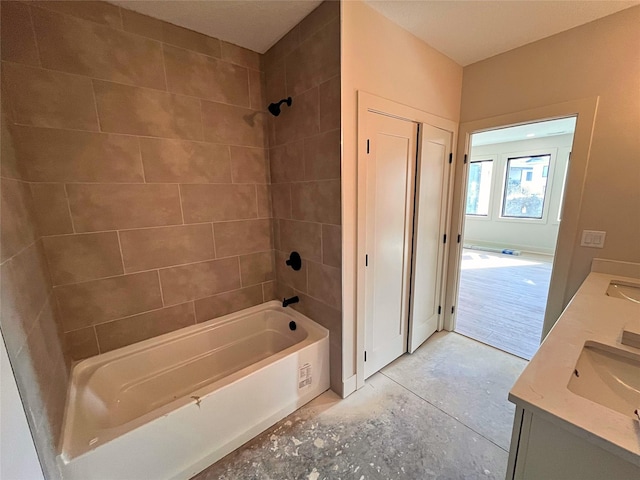 bathroom with vanity and tiled shower / bath combo