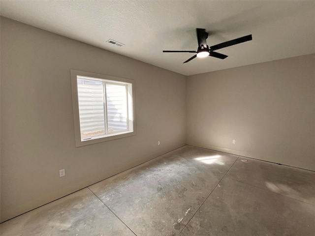 unfurnished room with concrete flooring, a textured ceiling, and ceiling fan