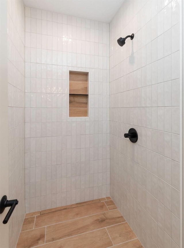 18016 Tanglewood Dr, Clive, IA 50325 - bathroom with a tile shower and wood finished floors