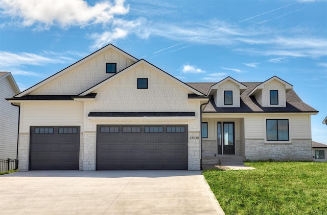 18016 Tanglewood Dr, Clive, IA 50325 - view of front of property with stone siding, driveway, an attached garage, a front lawn, and roof with shingles