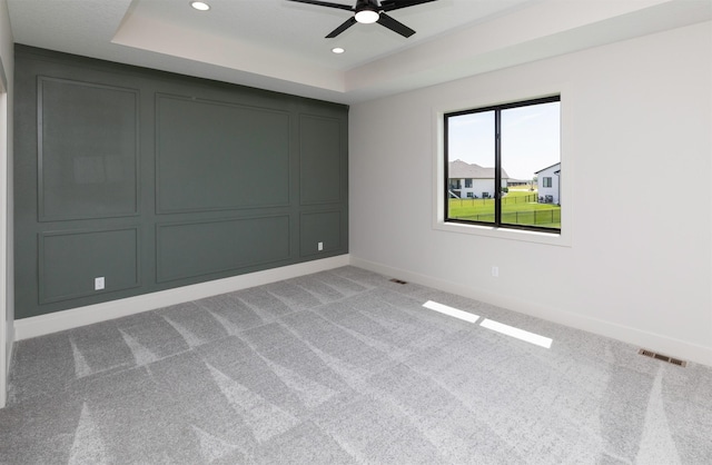 18016 Tanglewood Dr, Clive, IA 50325 - spare room with a raised ceiling, recessed lighting, a ceiling fan, and light carpet
