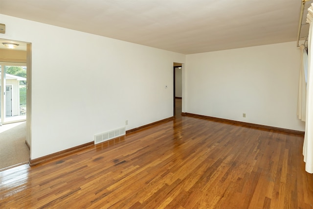 empty room with dark hardwood / wood-style floors