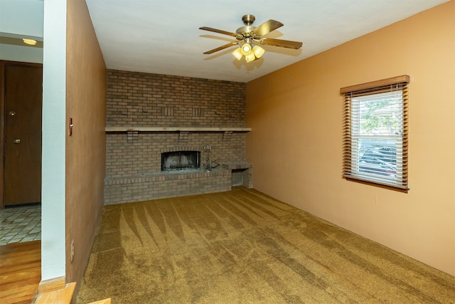 unfurnished living room featuring carpet, a fireplace, and ceiling fan