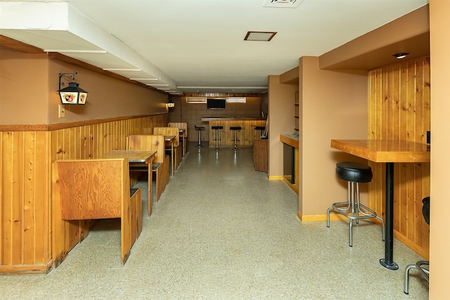 bar featuring wood walls